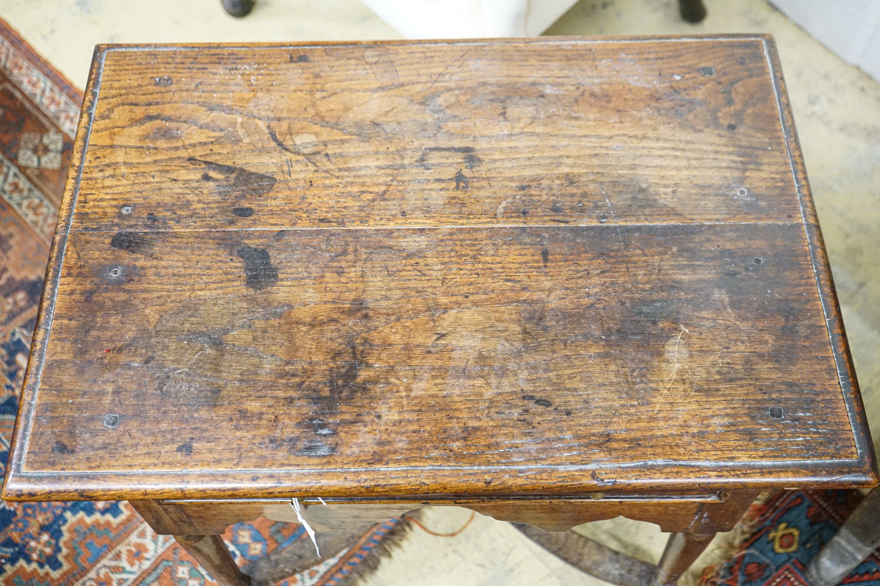 An early 18th century oak lowboy, with single drawer and saltire stretcher, width 67cm, depth 46cm, height 64cm